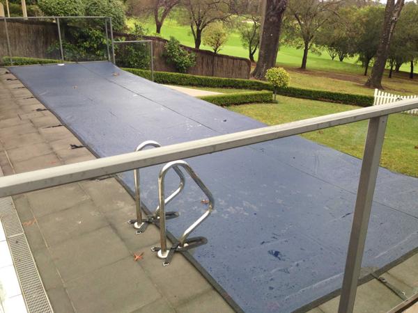 Pool cover on infinity edge pool