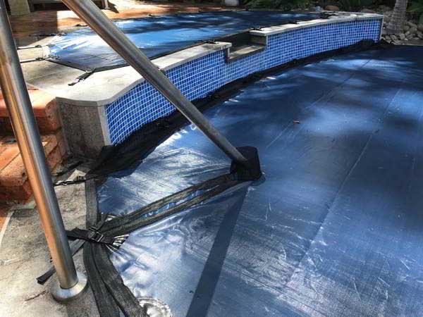 Custom-fitted pool cover for retaining wall in Canberra, seamlessly protecting and enhancing pool safety and aesthetics.