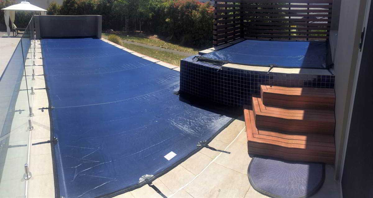 Custom-fit pool cover for feature or retaining wall in Canberra, perfectly sealed to safeguard the pool underneath.